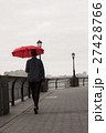 Young woman with umbrella walking by the river 27428766