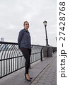 Young woman lost in thoughts by the river 27428768