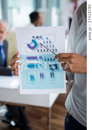 Businesswoman showing chart in office 27428780