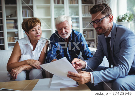 Senior couple planning their investments with financial advisor Senior couple planning their investments with financial advisor 27428949