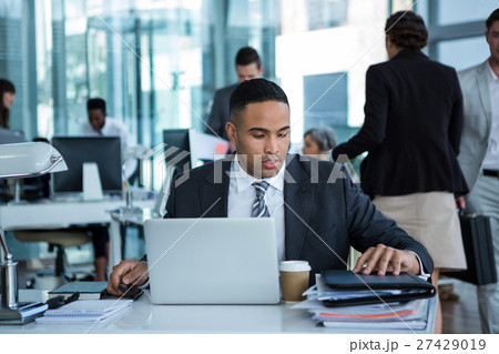 Businessman working on laptop Businessman working on laptop 27429019