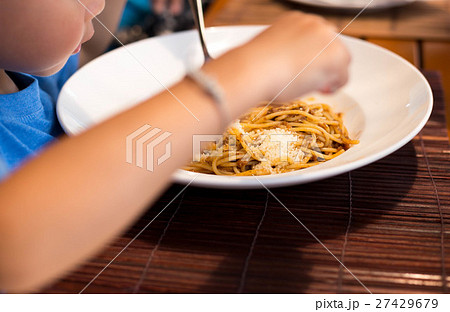 Selected focus little child enjoy eating spaghetti Selected focus little child enjoy eating spaghetti 27429679