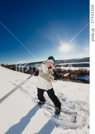 Young woman with the snowboard shooting a selfie  27433300