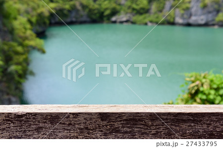 Wood plank over green lake and tree background. Wood plank over green lake and tree background. 27433795
