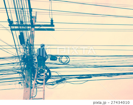 Electrician working on electric pole. Electrician working on electric pole. 27434010