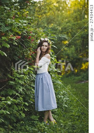 A girl near the Bush of the mountain ash 4793. 27434413