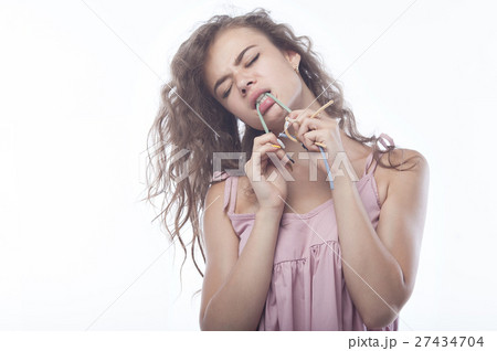 Portrait of beautiful girl with candy isolated on 27434704