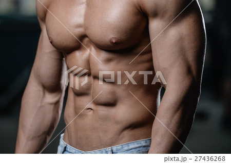 Strong and handsome athletic young man muscles abs Strong and handsome athletic young man muscles abs 27436268