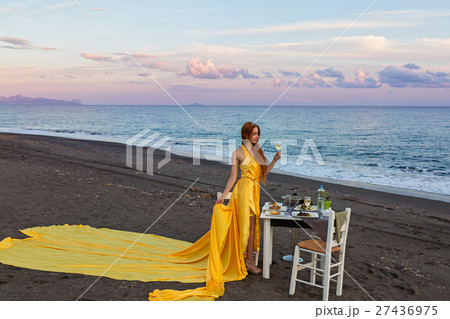 Beautiful woman in yellow dress on the seashore 27436975