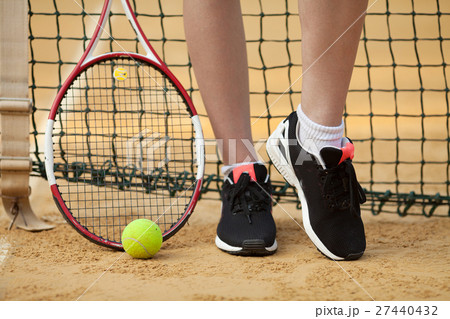 Clay tennis court with tennis player legs,ball 27440432