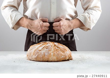 The male hands and rustic organic loaf of bread 27440911