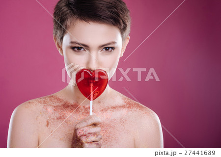 Pleasant young woman holding lollipop Pleasant young woman holding lollipop 27441689