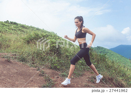 Cross-country female runner trail running on Cross-country female runner trail running on 27441962