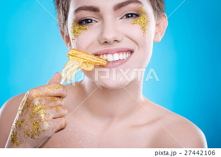 Joyful woman eating lollipop 27442106