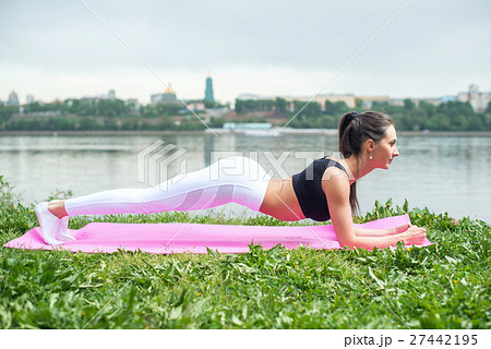 Fit woman working on back and abdominal muscles Fit woman working on back and abdominal muscles 27442195