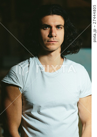 brutal guy with long hair on a dark background brutal guy with long hair on a dark background 27444805