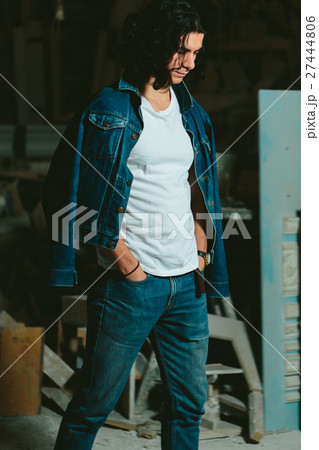 handsome man with long hair brunette in a denim 27444806