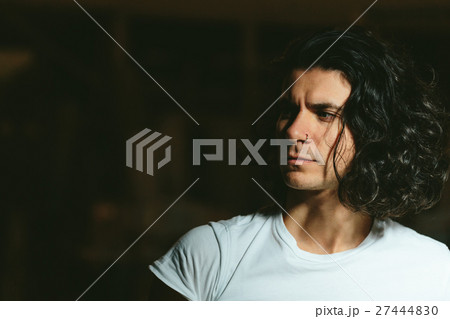 brutal guy with long hair on a dark background brutal guy with long hair on a dark background 27444830