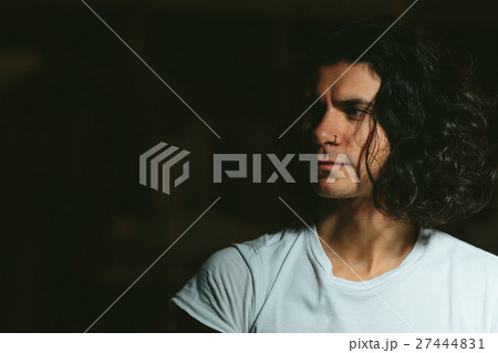 brutal guy with long hair on a dark background brutal guy with long hair on a dark background 27444831