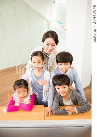 A Female Teacher And Her Young Students 27447640