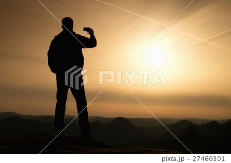 Tourist hold shinning phone, spring land 27460301