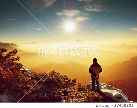 Tall hiker in black on rocky peak watch the world Tall hiker in black on rocky peak watch the world 27460303