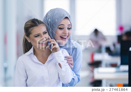 Young woman with mobile phone in the office Young woman with mobile phone in the office 27461864