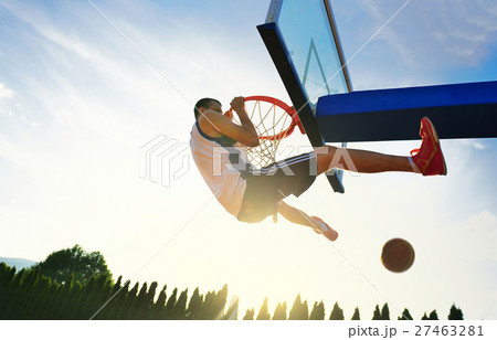 Street basketball player performing power slum Street basketball player performing power slum 27463281
