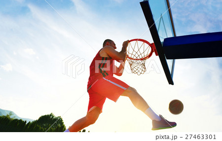 Young basketball player drives to the hoop for a 27463301