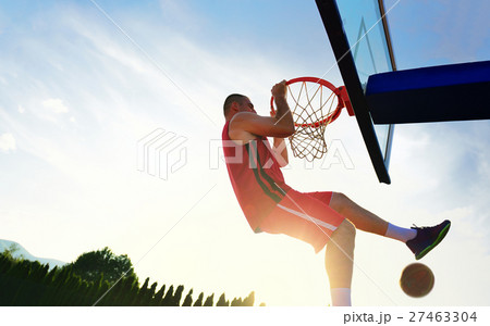 Young basketball player drives to the hoop for a 27463304