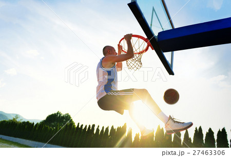 Young basketball player drives to the hoop for a 27463306