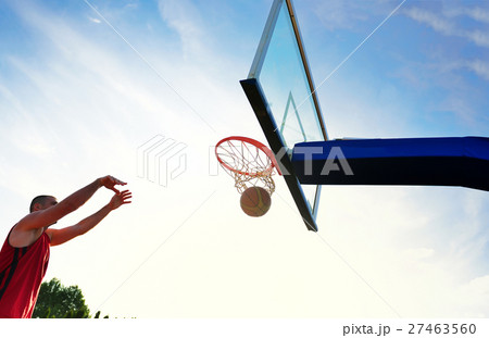 Young basketball player drives to the hoop for a 27463560