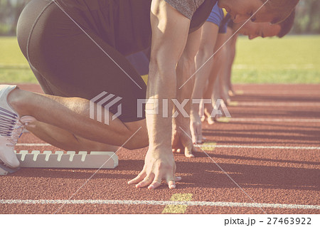 Male athletes at starting line on sunny day. 27463922