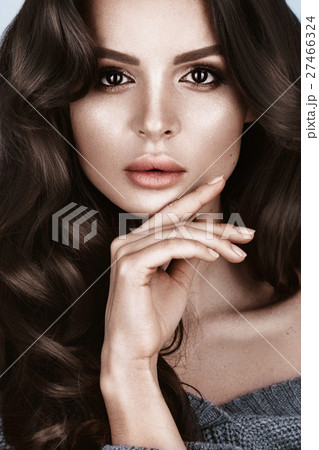 Beautiful woman with healthy skin and hair curls Beautiful woman with healthy skin and hair curls 27466324