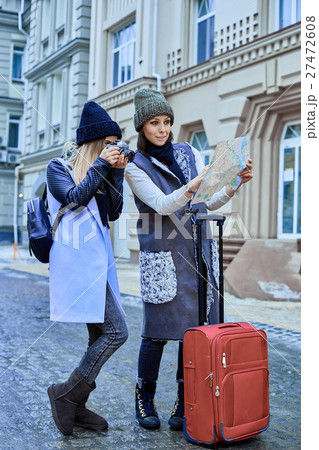 Two friends tourists choose attractions on the map Two friends tourists choose attractions on the map 27472608