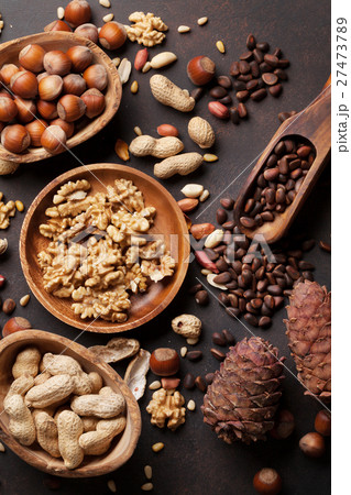 Various nuts on stone table Various nuts on stone table 27473789