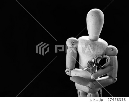 Still life wooden puppet and pink heart. Still life wooden puppet and pink heart. 27478358