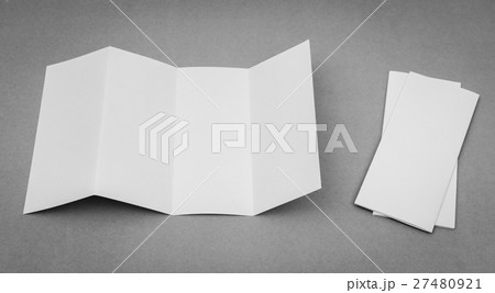 Four - fold white template paper on gray background . 27480921