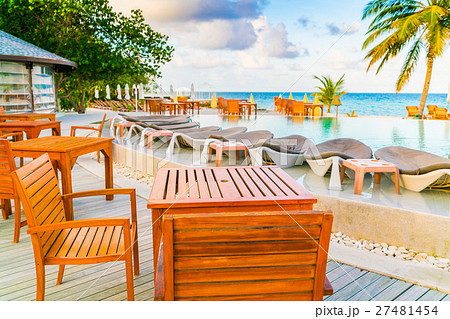 Table and chairs at restaurant in tropical Maldives island . Table and chairs at restaurant in tropical Maldives island . 27481454