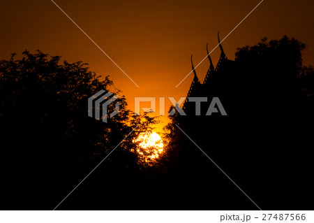 sunset with thai temple and tree silhouette 27487566