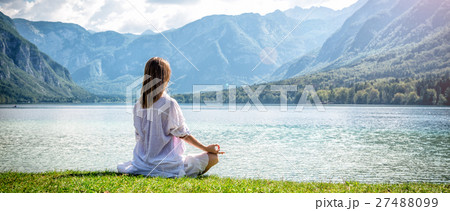 Woman meditating at the lake 27488099