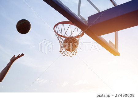 Basketball going through the basket Basketball going through the basket 27490609