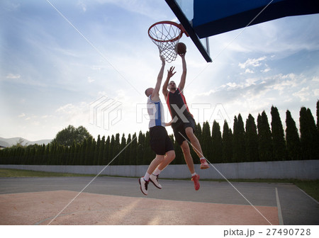 Two basketball players on the court outdoor 27490728