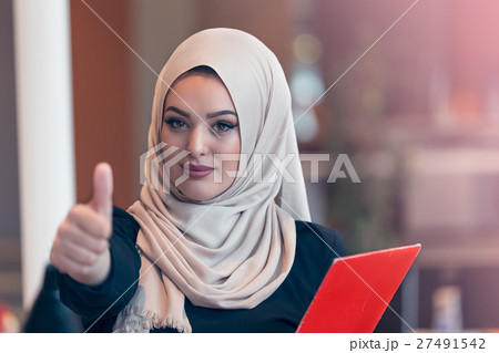 Arabian business woman holding a folder in modern Arabian business woman holding a folder in modern 27491542