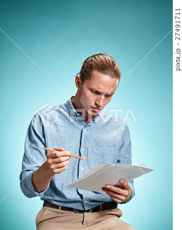 Smart sad student with sheets of paper Smart sad student with sheets of paper 27491711