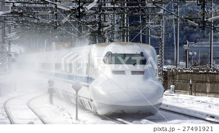 雪の米原駅を通過する700系 27491921