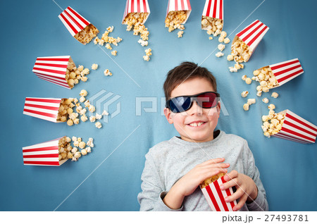 Child lying on blue background in 3d glasses and Child lying on blue background in 3d glasses and 27493781