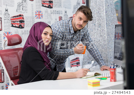 Arabic business woman wearing hijab,working in Arabic business woman wearing hijab,working in 27494543