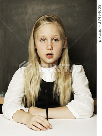 Little girl in school uniform is in classroom 27494605