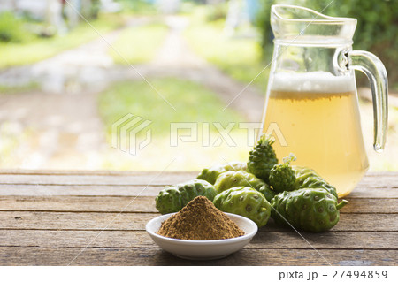 Noni fruit and noni juice with noni powder on wood 27494859